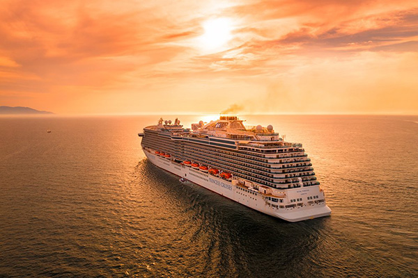 A cruise ship sailing into the sunset